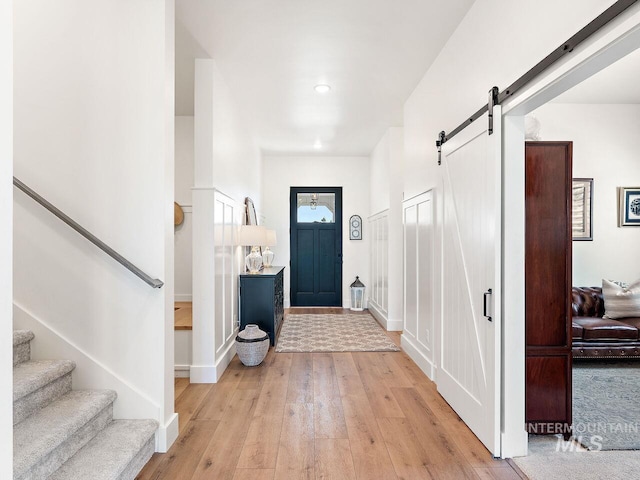 1305 N Big Star Pl, Eagle, ID 83616 - foyer featuring stairway, light wood finished floors, and a barn door