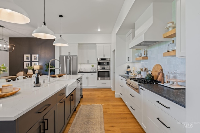 1305 N Big Star Pl, Eagle, ID 83616 - kitchen with appliances with stainless steel finishes, open shelves, white cabinetry, light wood-style floors, and backsplash