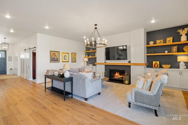1305 N Big Star Pl, Eagle, ID 83616 - living room with a barn door, a chandelier, light wood-type flooring, and recessed lighting
