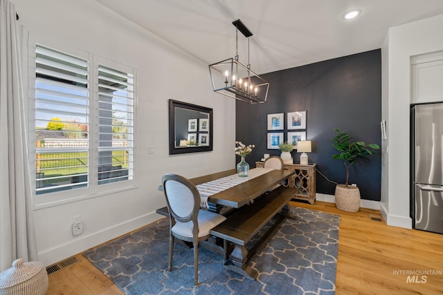 1305 N Big Star Pl, Eagle, ID 83616 - dining room with a chandelier, wood finished floors, and recessed lighting