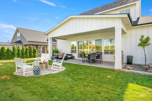 1305 N Big Star Pl, Eagle, ID 83616 - rear view of house with a shingled roof, board and batten siding, a patio, and a lawn