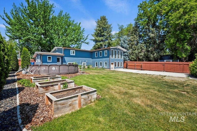 632 N Edgewood Ln, Eagle, ID 83616 - rear view of property with a gate and a vegetable garden