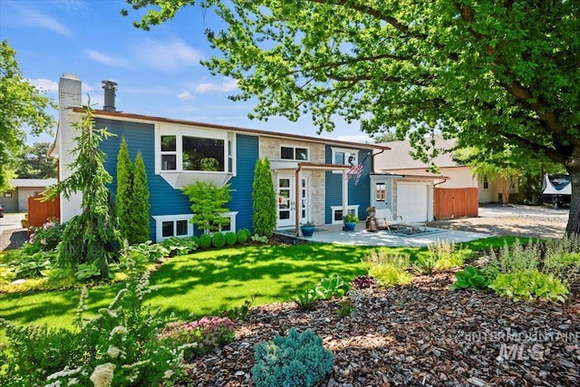 632 N Edgewood Ln, Eagle, ID 83616 - view of front of house with an attached garage, a front yard, and a chimney