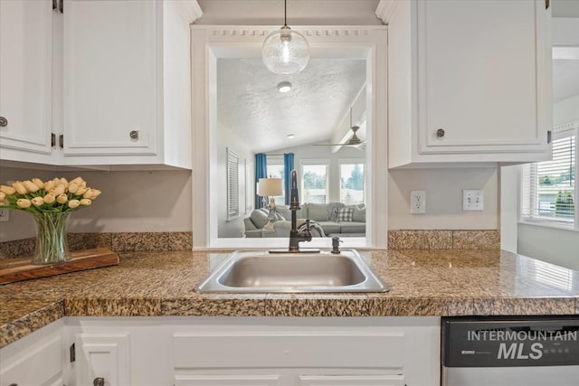 632 N Edgewood Ln, Eagle, ID 83616 - kitchen featuring white cabinetry, vaulted ceiling, hanging light fixtures, stainless steel dishwasher, and a textured ceiling
