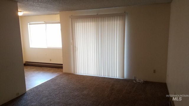 spare room featuring carpet floors, a textured ceiling, and a baseboard radiator