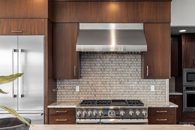 510 W Paso Fino Dr, Boise, ID 83702 - kitchen featuring built in appliances, wall chimney range hood, decorative backsplash, and light stone countertops