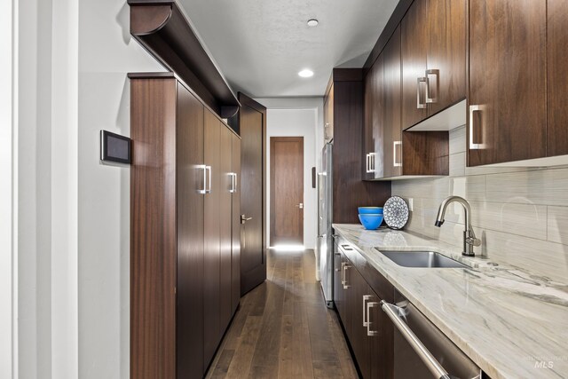 510 W Paso Fino Dr, Boise, ID 83702 - kitchen featuring sink, decorative backsplash, light stone counters, stainless steel appliances, and dark wood-type flooring