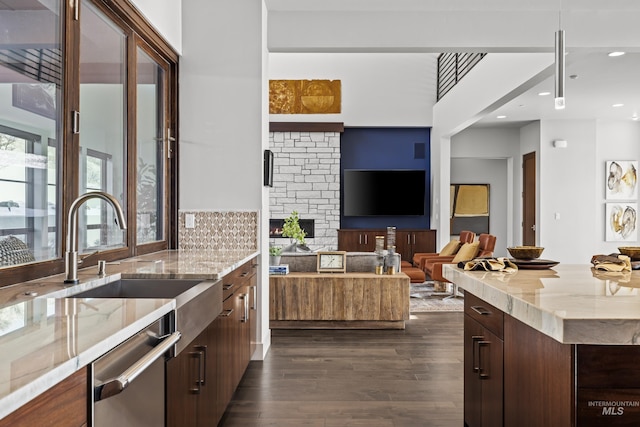 510 W Paso Fino Dr, Boise, ID 83702 - kitchen featuring sink, light stone counters, dark brown cabinets, dark hardwood / wood-style floors, and dishwasher