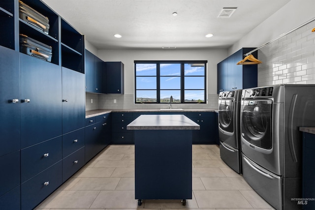 510 W Paso Fino Dr, Boise, ID 83702 - laundry room featuring separate washer and dryer, sink, and light tile patterned floors