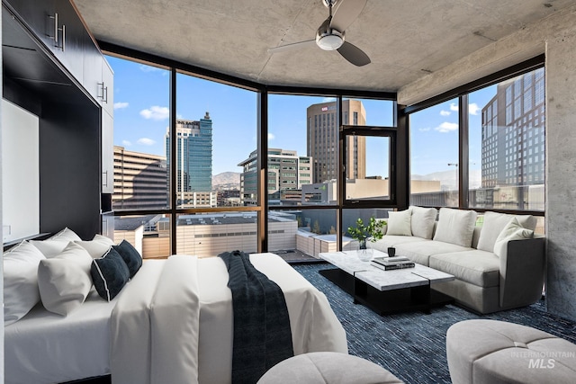 interior space with ceiling fan and a city view