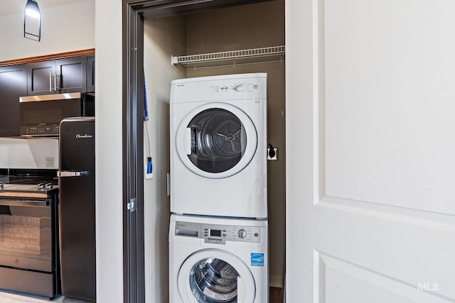 laundry area featuring stacked washer and dryer and laundry area