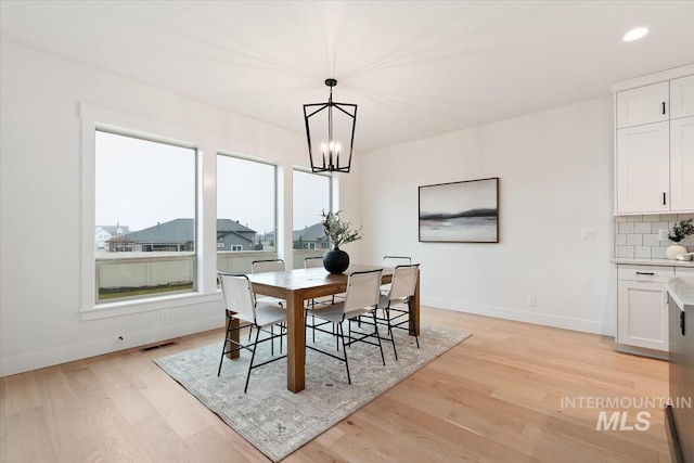 dining room featuring recessed lighting, visible vents, baseboards, light wood finished floors, and an inviting chandelier