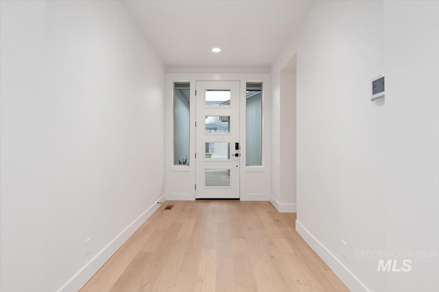 doorway to outside featuring light wood-style floors, visible vents, baseboards, and recessed lighting