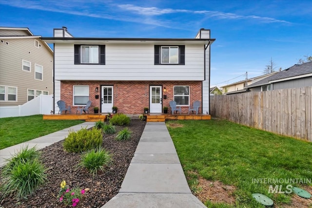918 N 32nd, Boise, ID 83703 - view of front of house with brick siding, a fenced backyard, and a chimney
