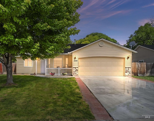 5609 Landsdown Ave, Caldwell, ID 83607 - ranch-style home with concrete driveway, stone siding, a porch, and an attached garage