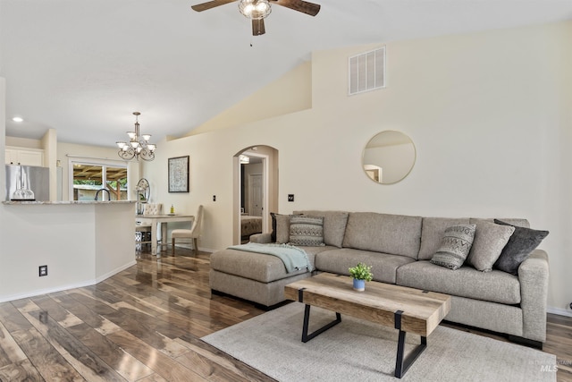5609 Landsdown Ave, Caldwell, ID 83607 - living room featuring arched walkways, dark wood-type flooring, a ceiling fan, a chandelier, and lofted ceiling