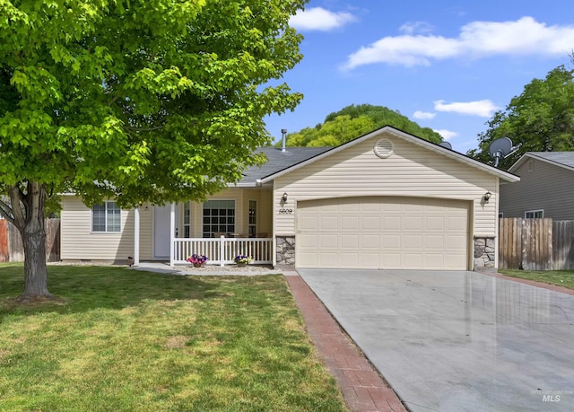 5609 Landsdown Ave, Caldwell, ID 83607 - single story home with a porch, stone siding, a garage, and driveway