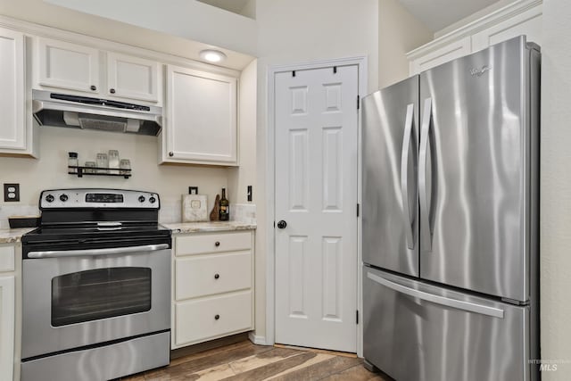 5609 Landsdown Ave, Caldwell, ID 83607 - kitchen with appliances with stainless steel finishes, under cabinet range hood, white cabinets, wood finished floors, and light stone countertops