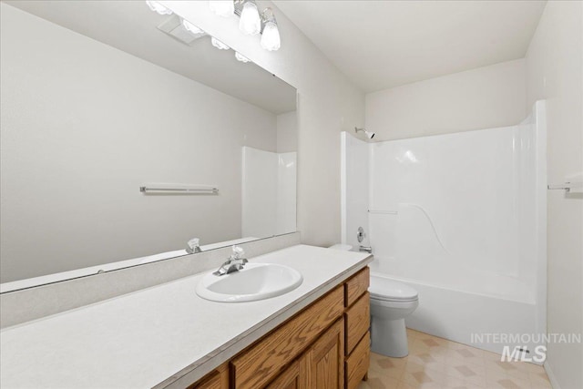 bathroom with washtub / shower combination, toilet, vanity, and tile patterned floors