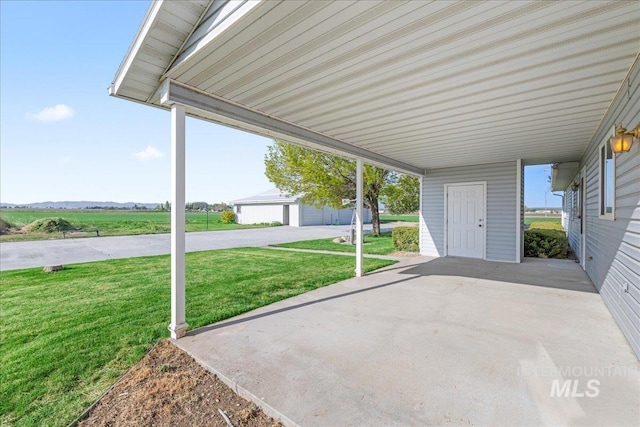 view of patio with an outdoor structure and an attached carport