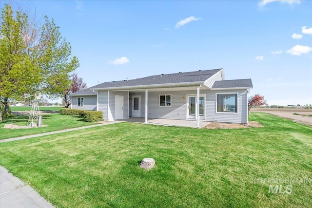 view of front of property featuring a front lawn and a patio