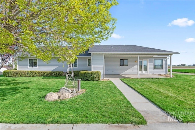 view of front of home with a patio and a front yard
