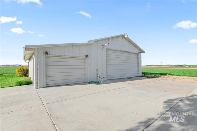 detached garage featuring a rural view