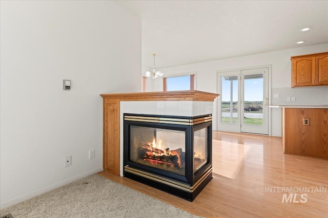 room details with recessed lighting, wood finished floors, baseboards, and a notable chandelier