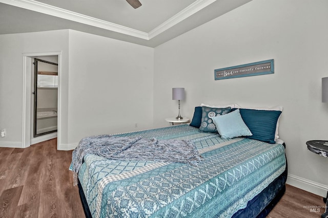 bedroom featuring wood finished floors, ornamental molding, and baseboards