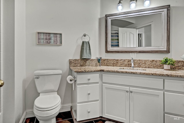 full bath featuring baseboards, toilet, and vanity