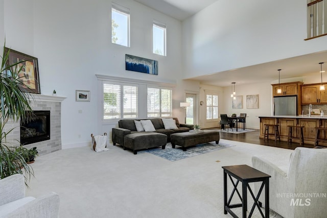2581 N Tricia Way, Meridian, ID 83646 - living room featuring a high ceiling, a tile fireplace, and baseboards