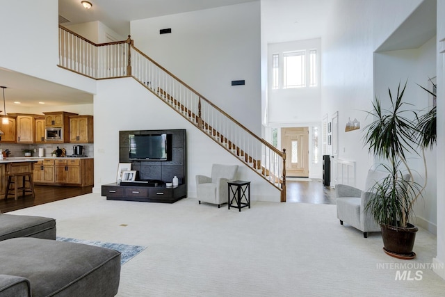 2581 N Tricia Way, Meridian, ID 83646 - living area with a high ceiling, stairway, and dark carpet