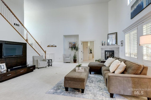 2581 N Tricia Way, Meridian, ID 83646 - carpeted living room with a towering ceiling, a fireplace, and stairs