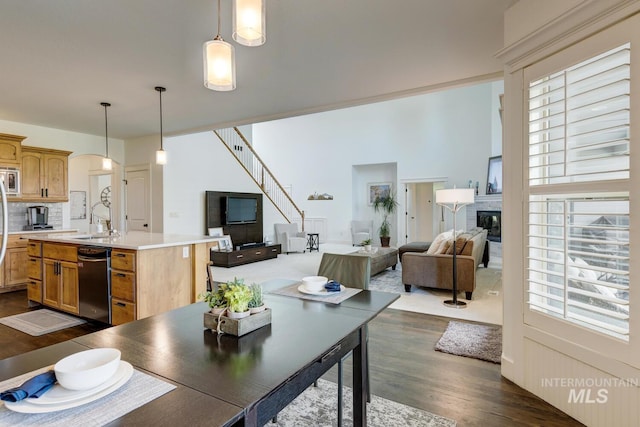 2581 N Tricia Way, Meridian, ID 83646 - dining space featuring dark wood-style floors, a glass covered fireplace, plenty of natural light, and arched walkways