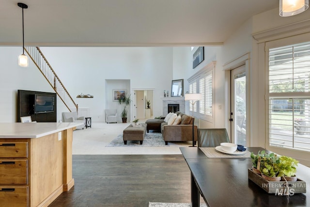 2581 N Tricia Way, Meridian, ID 83646 - living area featuring dark wood-style flooring, a brick fireplace, and stairway
