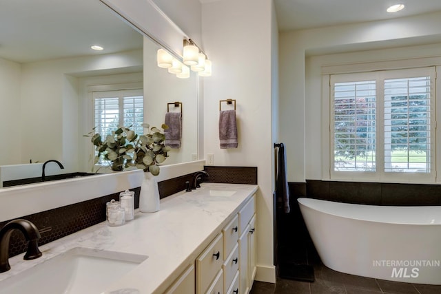 2581 N Tricia Way, Meridian, ID 83646 - bathroom with a freestanding tub, double vanity, tile patterned floors, and recessed lighting