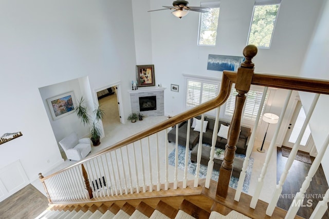 2581 N Tricia Way, Meridian, ID 83646 - stairway with a high ceiling, plenty of natural light, a fireplace, a ceiling fan, and wood finished floors