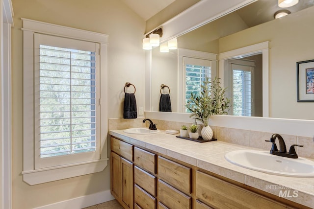 2581 N Tricia Way, Meridian, ID 83646 - bathroom featuring healthy amount of natural light, double vanity, and vaulted ceiling