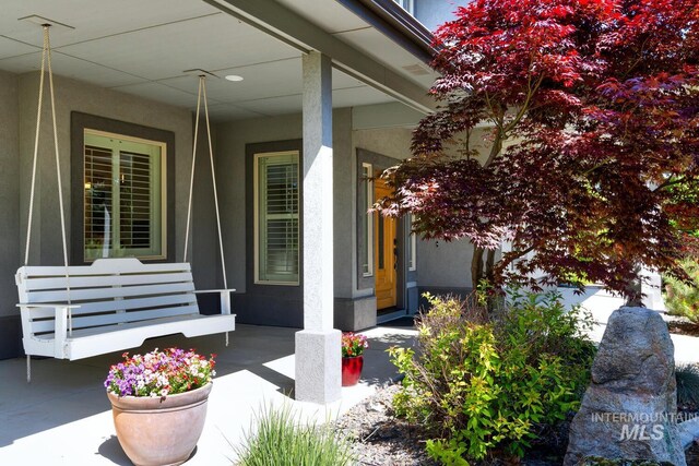 2581 N Tricia Way, Meridian, ID 83646 - doorway to property with covered porch and stucco siding