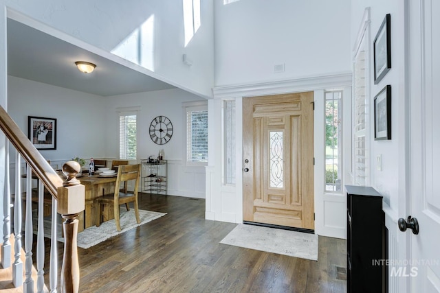 2581 N Tricia Way, Meridian, ID 83646 - foyer featuring dark wood-type flooring, a high ceiling, a decorative wall, wainscoting, and stairway