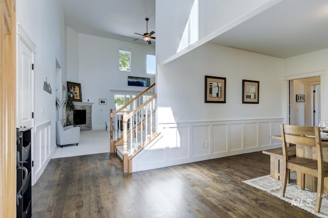 2581 N Tricia Way, Meridian, ID 83646 - foyer featuring a ceiling fan, a fireplace, stairs, dark wood finished floors, and a high ceiling