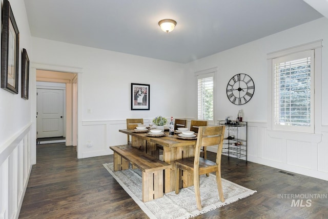 2581 N Tricia Way, Meridian, ID 83646 - dining space featuring wainscoting, a decorative wall, plenty of natural light, and dark wood-style flooring