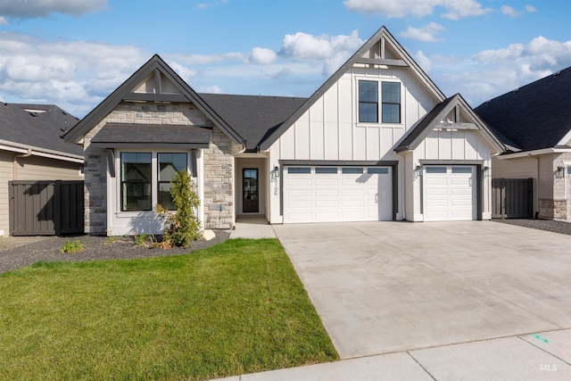 view of front of property featuring board and batten siding, concrete driveway, stone siding, and an attached garage