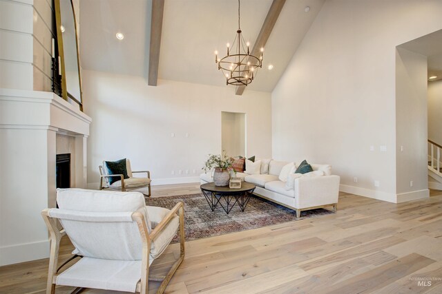 living room with high vaulted ceiling, a chandelier, beam ceiling, baseboards, and light wood finished floors