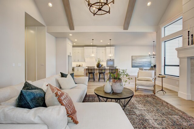 living area with a chandelier, light wood finished floors, and recessed lighting