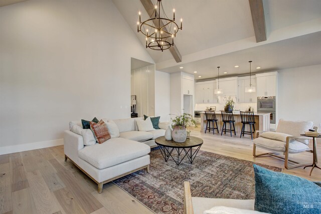 living room with high vaulted ceiling, light wood-type flooring, a chandelier, recessed lighting, and beam ceiling