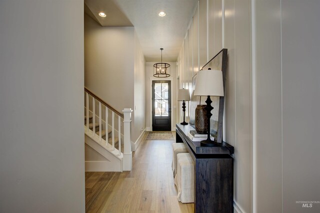 entrance foyer with light wood-style floors, stairway, recessed lighting, a chandelier, and baseboards