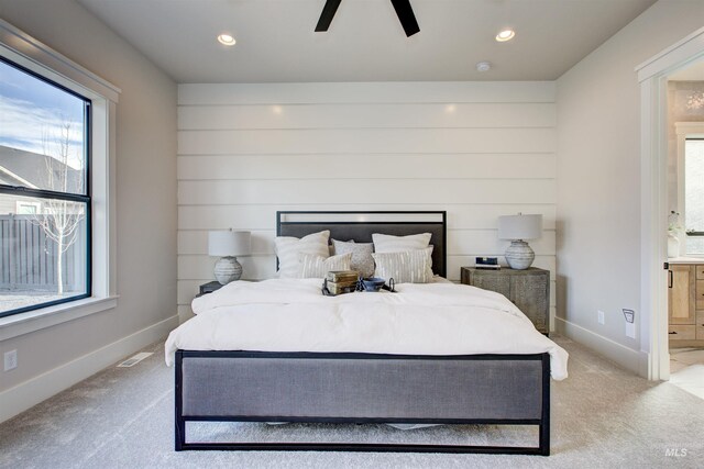 bedroom featuring multiple windows, ensuite bath, carpet floors, and recessed lighting