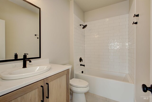 bathroom with toilet, vanity, tile patterned flooring, and shower / bathtub combination