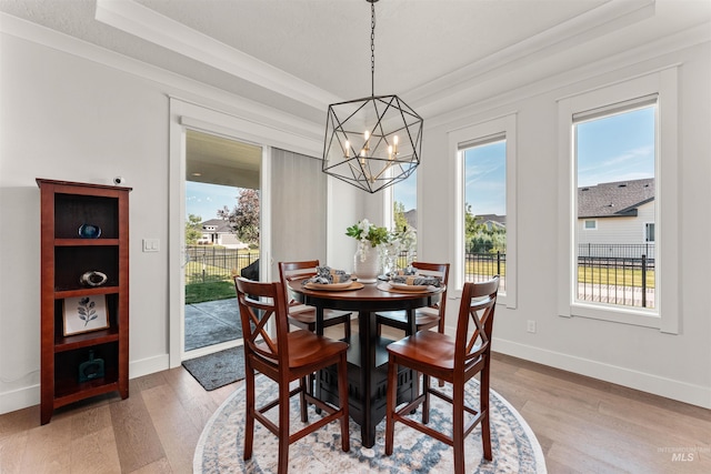 2255 N Sugar Loop Ave, Star, ID 83669 - dining space with a chandelier, light wood-type flooring, a tray ceiling, and healthy amount of natural light